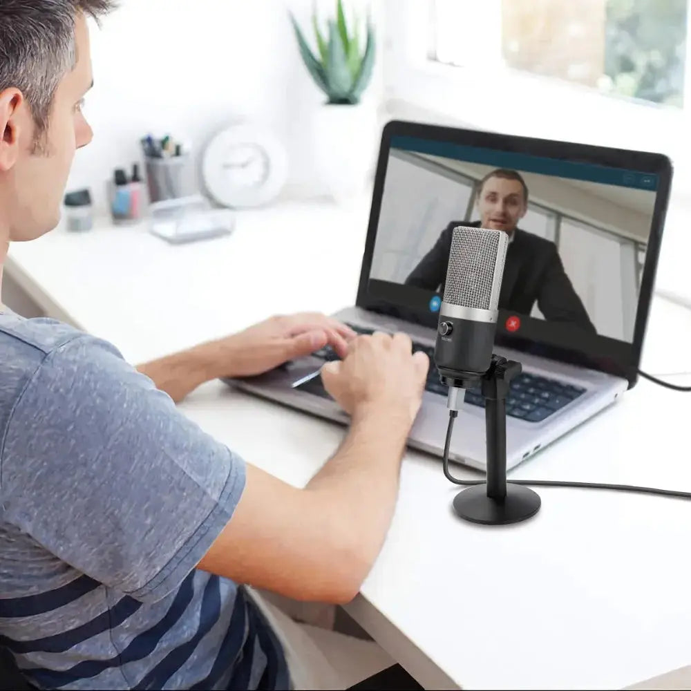 a man sitting in front of a laptop computer